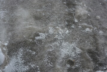 Nature, frozen ice, a thick ice floe of the Dnipro River with white snow.