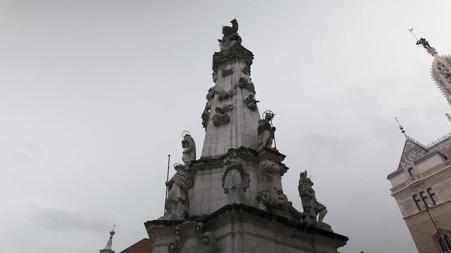 Low angle POV circles Holy Trinity Statue at Matthias Church, Budapest