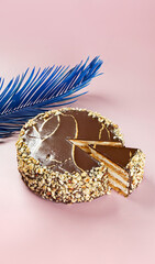 birthday cake with cream and chocolate and a blue feather