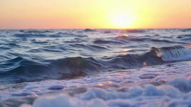 HD 4K Video of Ocean Waves at sunset. Gentle waves crashing on the shore as the sun dips below the horizon. 