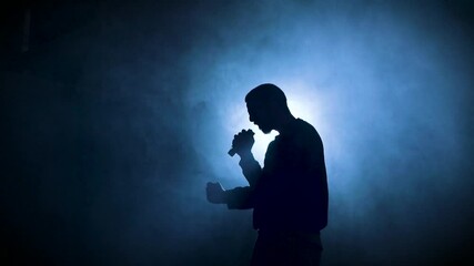 Silhouette of a man singing with a microphone at a concert. Singer artist performing. High quality 4k footage - Powered by Adobe