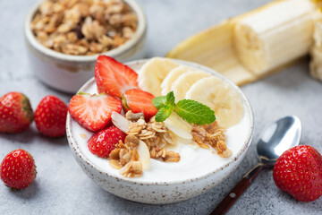 Yogurt bowl with granola, berries and fruits. Healthy breakfast or snack meal