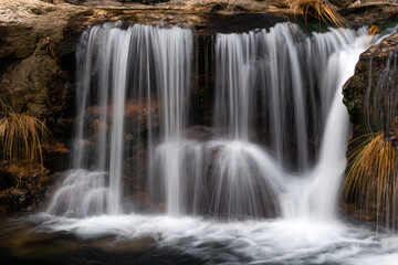 Serene waterfall cascading over rocks, creating a peaceful and refreshing scene. Long exposure captures the smooth flow of water. Loureza - Galicia - Spain