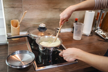 Cooking a delicious creamy dish in a cozy kitchen on a sunny afternoon