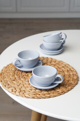 Ceramic mug with saucer on kitchen light table