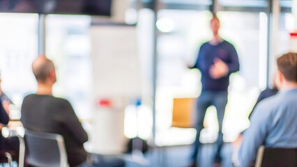 Fototapeta premium Training Session Blur: A blurred image of a trainer and participants in a corporate setting. 