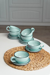 Ceramic mug with saucer on kitchen light table