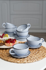 Ceramic mug with saucer on kitchen light table