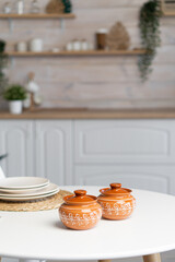 Ceramic mug with saucer on kitchen light table