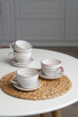 Ceramic mug with saucer on kitchen light table