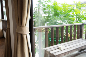 Modern curtain with sofa in hotel room wooden decorate in earth tone tropical