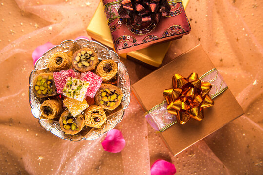 Eid festival gift background. A top view of middle eastern sweet and many gift packs arranged together.
