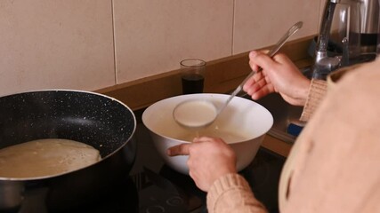 Woman Making Pancakes or Crepes for Shrove Tuesday, Pancake Day, or Maslenitsa