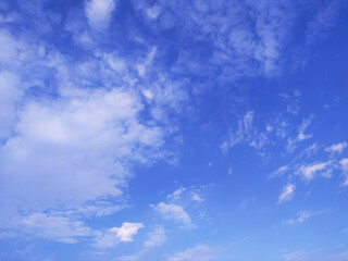 Clear blue sky texture and white fluffy cloud nature background. The sun shines bright in the daytime in summer