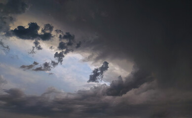 Dramatic cloud formation fills the sky during an overcast evening, hinting at an approaching storm