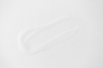 Aloe gel smear on white background, close-up. Pure transparent facial cleanser, peeling, shampoo or shower gel