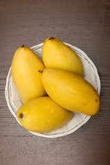yellow mangoes on the table in a cut form