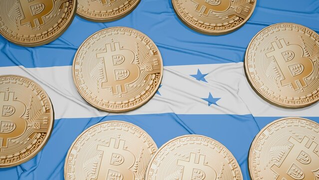 Several bitcoins are laid out on the flag of Honduras