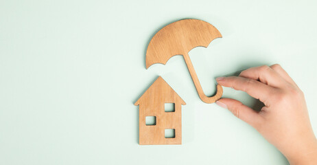 man holding wooden umbrella and house © ARAMYAN