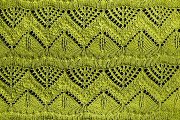 Textured green openwork close-up crocheted. Green patterned background