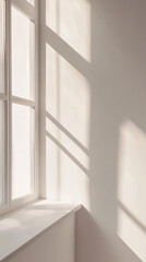 Fototapeta premium Sunlight streams through the window, illuminating a modern, empty interior space with soft shadows.
