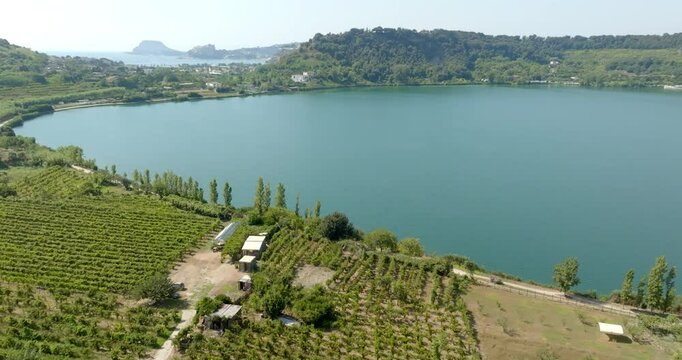Aerial view of the lakeside of Lago d'Averno located in Pozzuoli, near Naples, Italy. It is a volcanic lake located in the Campi Flegrei. The lake is approximately circular.