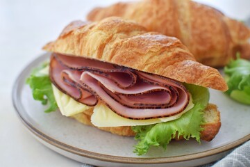 Croissant sandwich with ham and cheese.