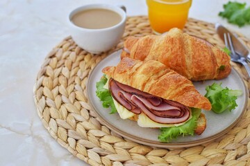 Breakfast with croissant sandwiches on the table