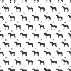 Seamless pattern of black horse silhouettes and horseshoes on a white background, creating an elegant equestrian design