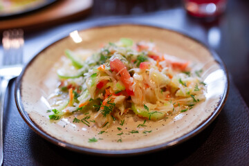 Fresh vegetable salad with tomatoes, cucumbers and celery on plate