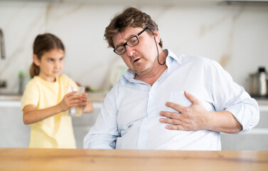 Daughter gives water to father whose heart hurts