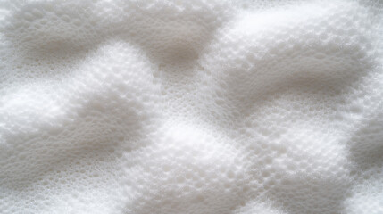 Obraz premium A close-up view reveals smooth, white foam showcasing intricate patterns and soft curves. The lighting highlights the texture, creating an interesting visual effect that draws the eye
