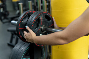 Close up view, woman's hands holding weights in the gym, training and workout concept