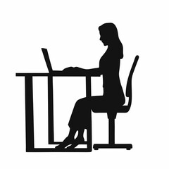 A woman is sitting at a desk with a laptop. She is wearing a black shirt and black pants