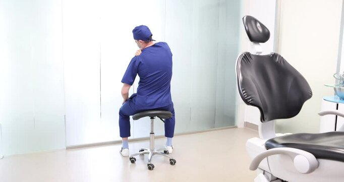 Sitting dentist, dealing with arm muscle pain.Symptoms and self help exercises, stretching. Back view.