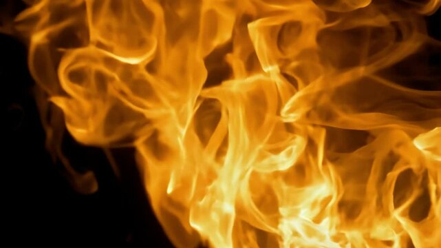 Burning flames spreading on black background