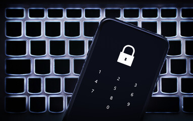 Data privacy in phone with password code. Smartphone on laptop keyboard. Lock to protect personal bank from hacker, cyber fraud or online scam. Protection with 2fa verification. Pin number.