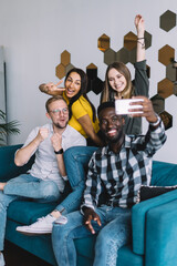 Positive multiethnic group of friends taking selfie