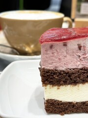 Close-up of chocolate and strawberry mousse cake with coffee