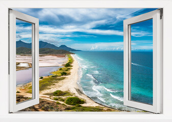 Window with a view of the ocean and mountains