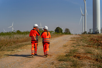 Engineers work at windmill farm.