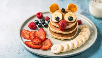 Funny bear pancakes with fresh fruits for a healthy children breakfast