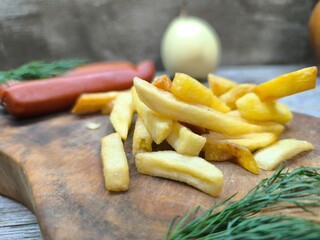 Close-up with French fries and delicious sausage . high quality photos.