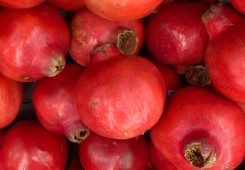 A close-up of several pomegranates isolated against white background