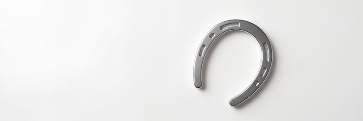 Silver horseshoe in minimalist style on white background with copy space