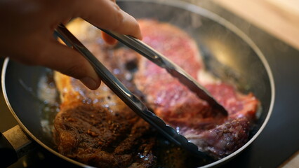 Cooking steak on pan close-up