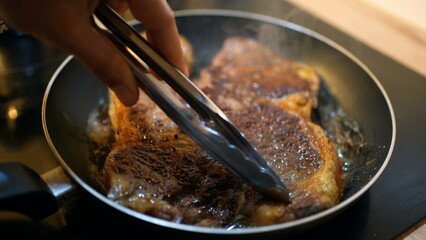Cooking steak on pan close-up
