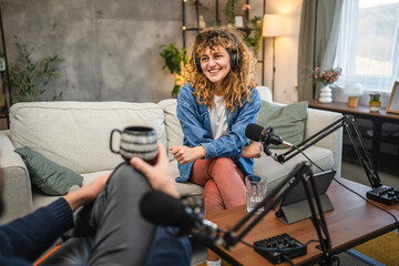 female guests with headphones answer on questions to male presenter