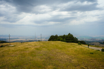 Fototapeta premium View from mountains across valley to south east with city of Stip on center horizon. Stip, Macedonia 