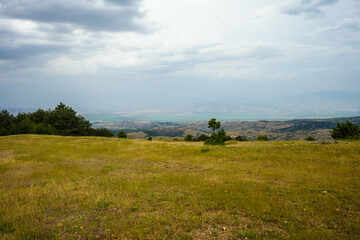 Fototapeta premium View from mountains across valley to south east with city of Stip on center horizon. Stip, Macedonia 